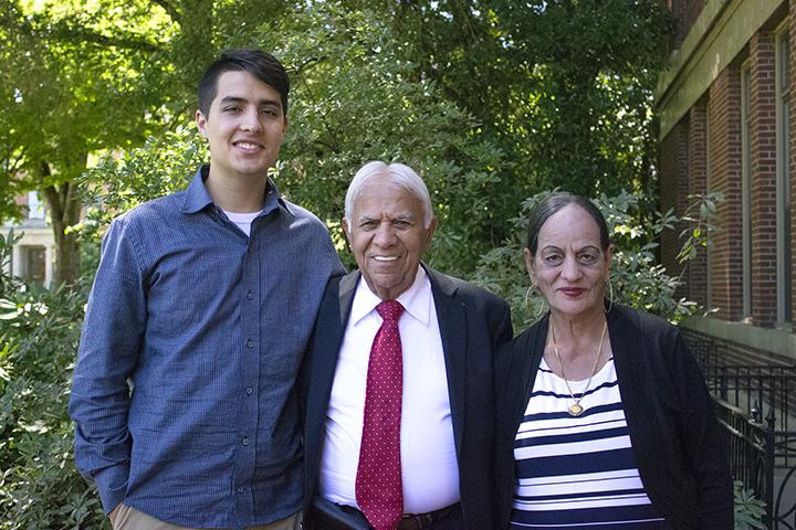 Satnam Sethi with grandson and wife standing in front of Kidder Hall