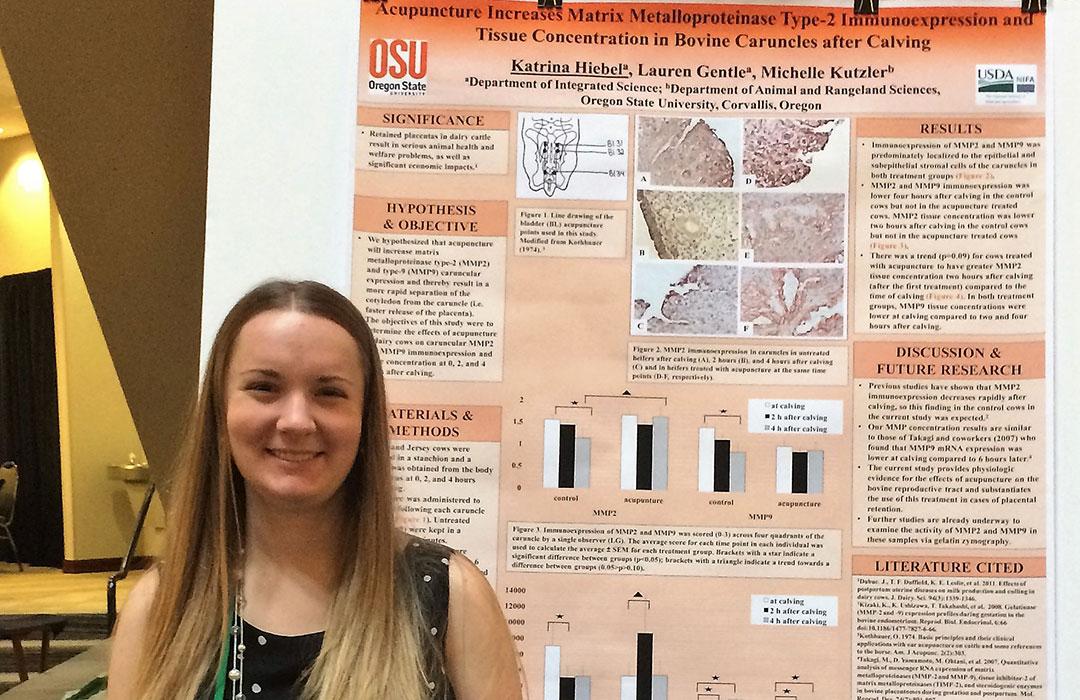 Katrina Heibel standing next to research poster