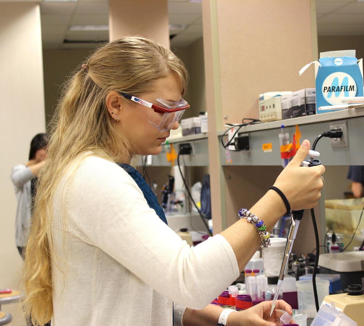 female student working with samples in lab
