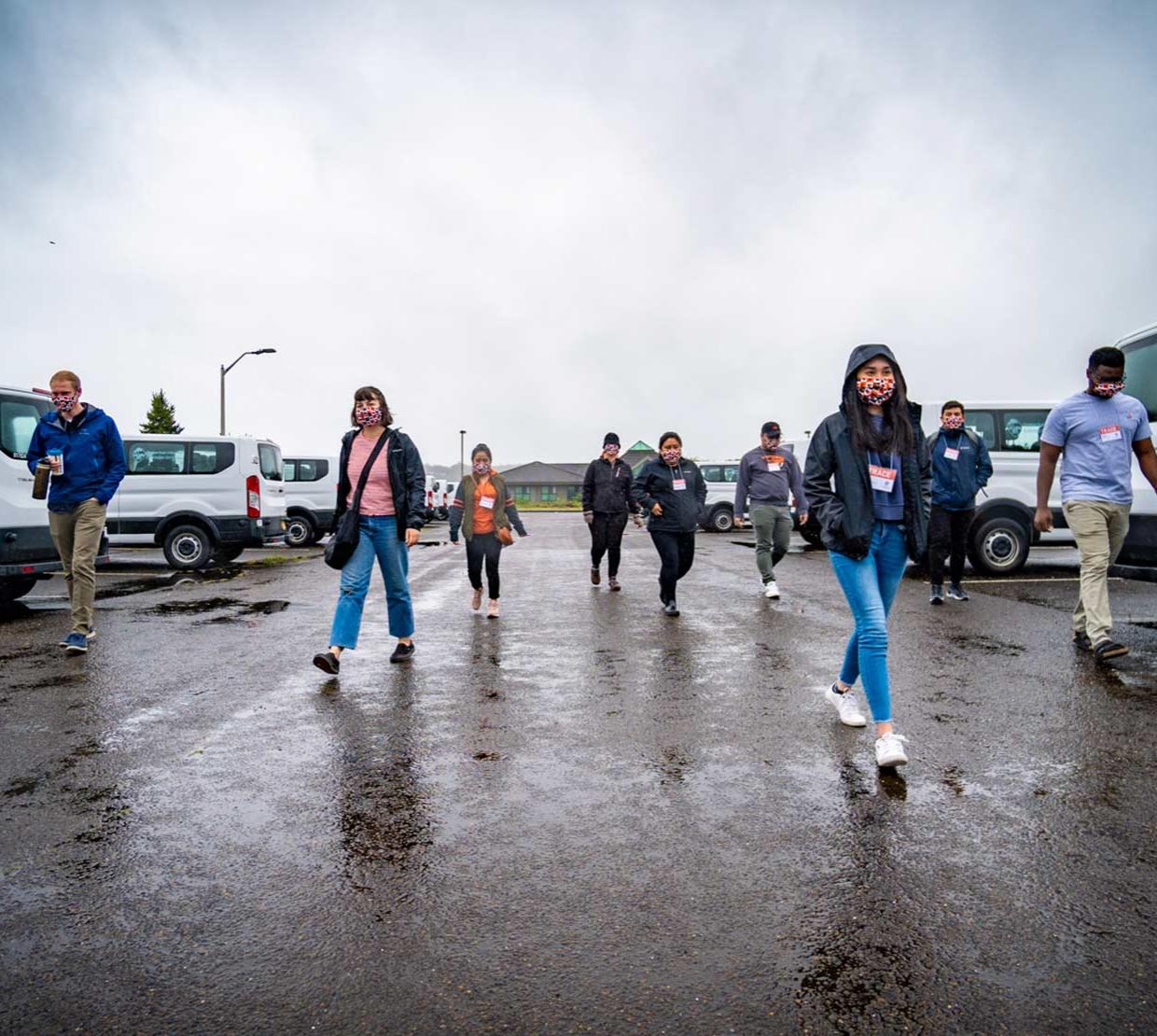 TRACE employees walking in parking lot on a cloudy, wet day in Newport, Oregon