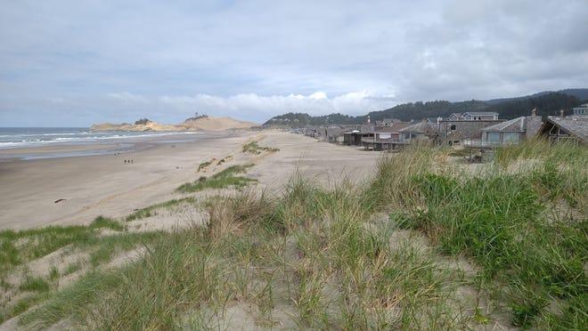 Sandy dunes between the Oregon coast and beachfront properties