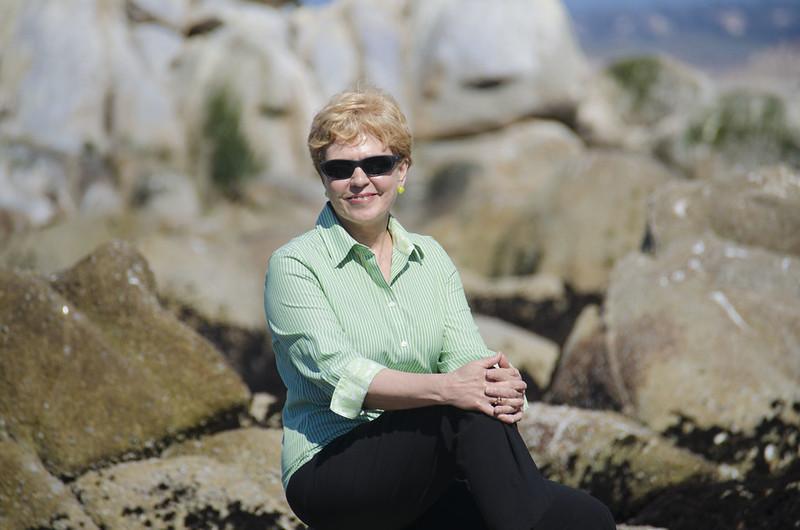 Jane Lubchenco sitting on rocks