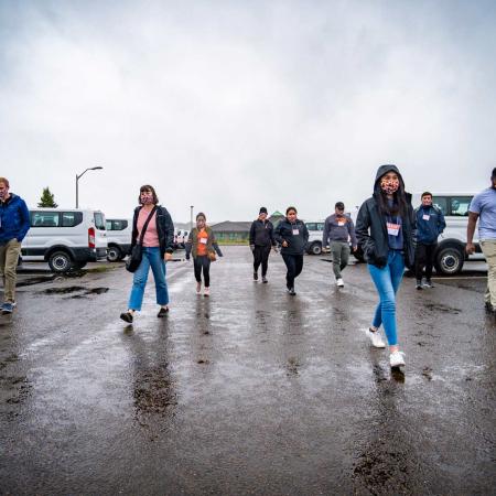 TRACE employees walking in parking lot on a cloudy, wet day in Newport, Oregon