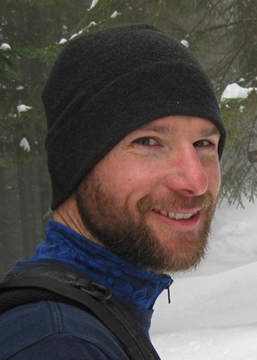 Mark Novak standing in snowy forest
