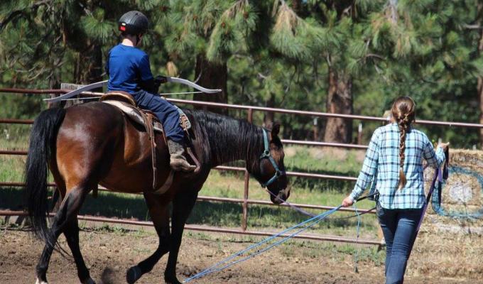 Prema Nissinen riding horses on farm