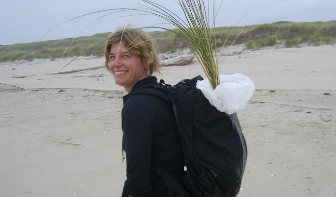 Sally D. Hacker walking though sand dune