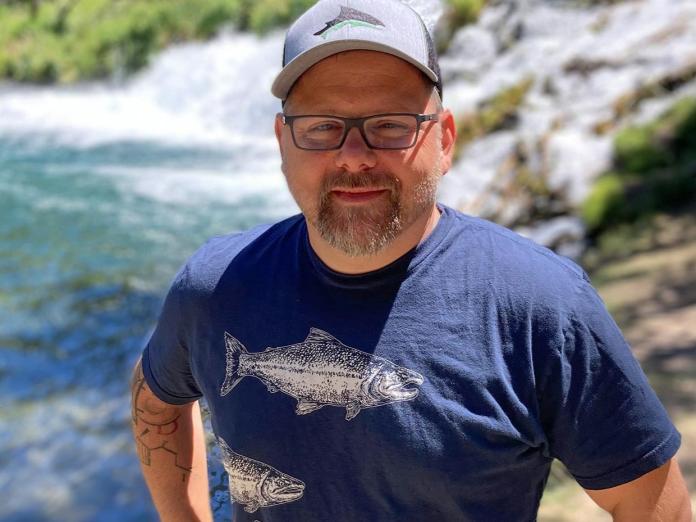 Jason Podrabsky on field work by a river