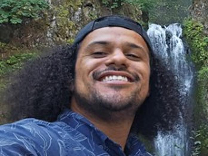 selfie of Dustin Campbell with waterfall behind