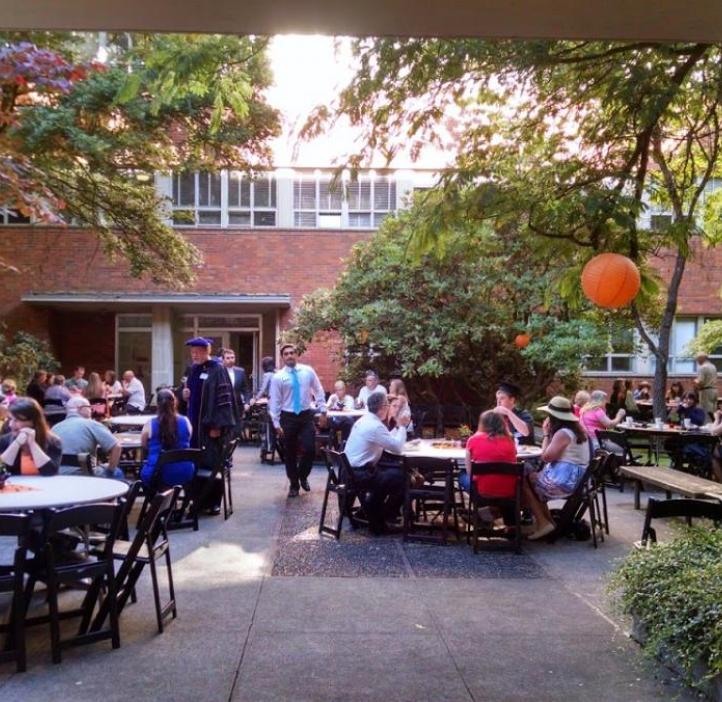 wide shot of students and families at tables in the cordley courtyard