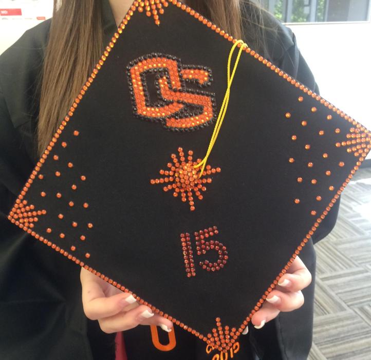 Mortarboard decorated with the Oregon State logo in orange rhinestones